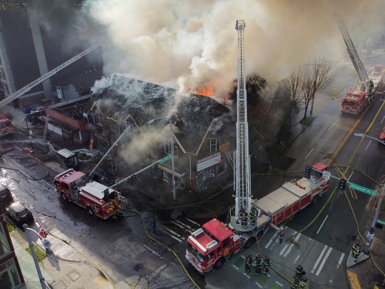 Firefighters battle flames as the old shuttered Seven Gables Theatre burns Thursday in Seattle’s University District. (Ken Lambert / The Seattle Times)