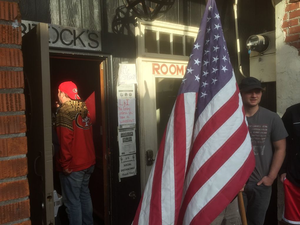 Patrons of Brock’s Bar & Grill in Woodland, Cowlitz County, head into a Sunday afternoon opening for bar drinks and food in defiance of state COVID-19 restrictions. (Hal Bernton / The Seattle Times)