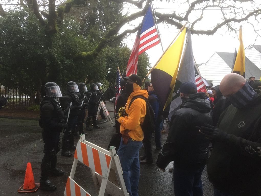 Oregon state police form a line to protect the Salem residence of Gov. Kate Brown — Mahonia Hall — on New Year’s Day. Protesters gathered to oppose COVID-19 restrictions.  (Hal Bernton / The Seattle Times)