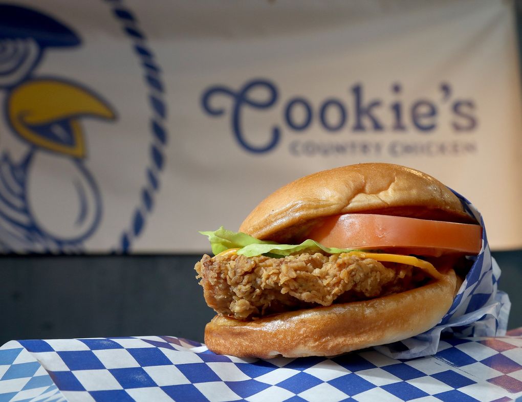 At Cookie’s Country Chicken, at Quality Athletics on South King Street, you’ll find this chicken country sandwich with iceberg lettuce, tomato, cheese and “sunny sauce.” (Greg Gilbert / The Seattle Times)
