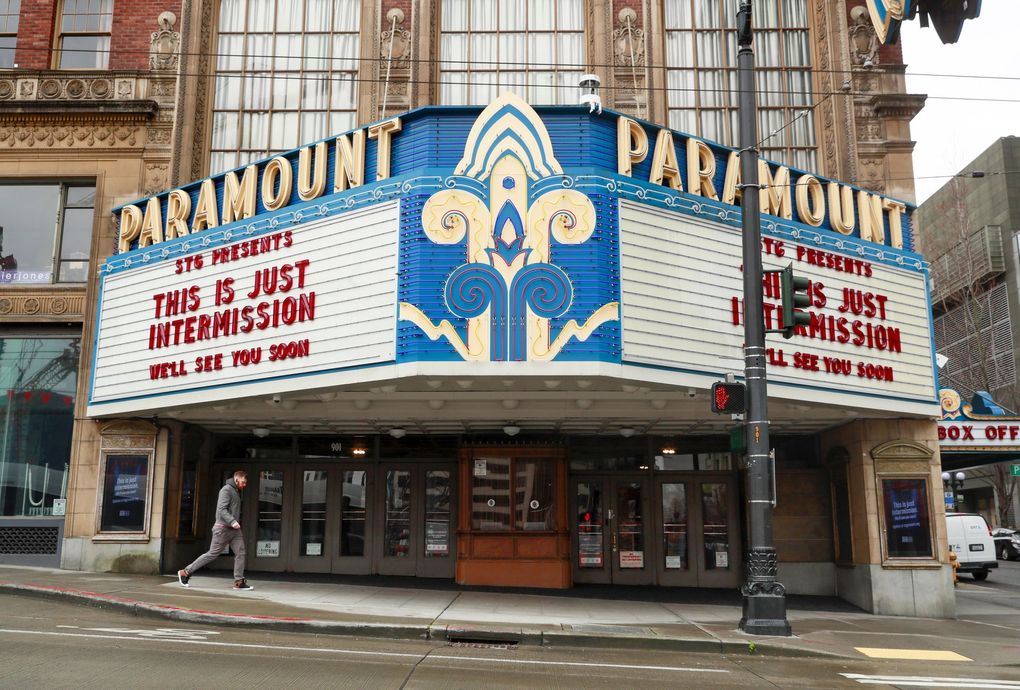 State Senate Bill 5114 would speed the reopening of businesses and put legislators, not Gov. Jay Inslee, in charge of the process. Above, a pedestrian walks past a closed Paramount Theatre in Seattle.  (Erika Schultz / The Seattle Times, file photo)