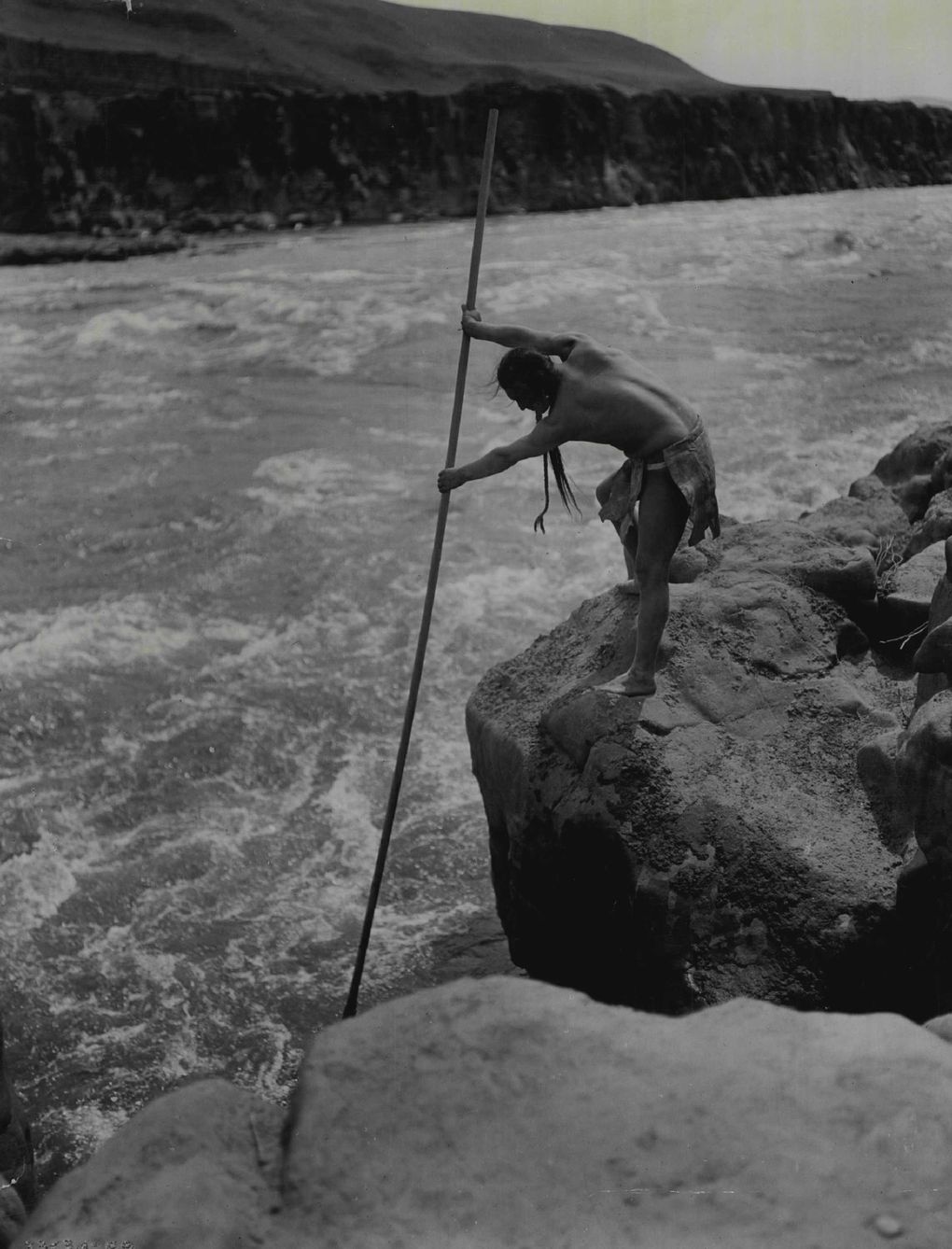 This 1909 picture of an Indian spearing fish on the Columbia River is a well-known Edward Curtis classic, titled “The Fisherman.” Celilo Falls was one of the greatest Indigenous fisheries in the world, and a center of Native trade, sustenance and culture for more than 10,000 years. The Dalles Dam flooded the falls in 1957. (Edward S. Curtis / The Seattle Times archive)