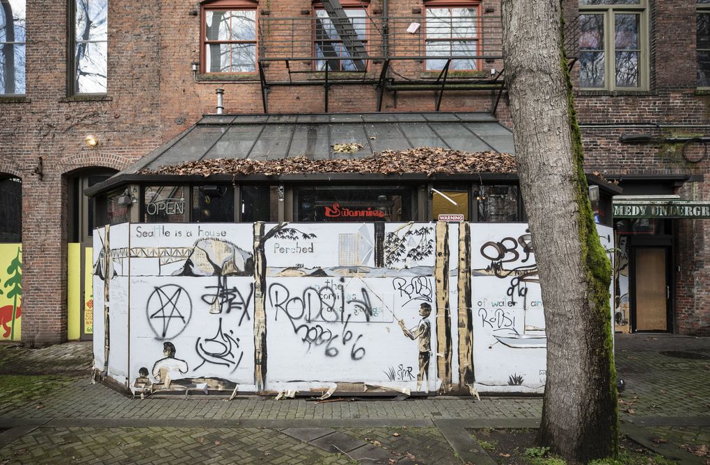 Buildings and businesses are still boarded up in Seattle’s Pioneer Square. (Steve Ringman / The Seattle Times)