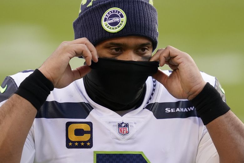 Seattle Seahawks quarterback Russell Wilson (3) adjusting his face covering at the end of an NFL football game against the Washington Football Team, Sunday, Dec. 20, 2020, in Landover, Md. Seattle won 20-15. (AP Photo/Andrew Harnik) otkm189 otkm189 (Andrew Harnik / The Associated Press)