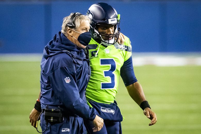 Seahawks head coach Pete Carroll puts his arm around quarterback Russell Wilson as he is tasked with leading a fourth-quarter comeback as the Seattle Seahawks take on the Minnesota Vikings at CenturyLink Field in Seattle Sunday October 11, 2020. (Bettina Hansen / The Seattle Times)