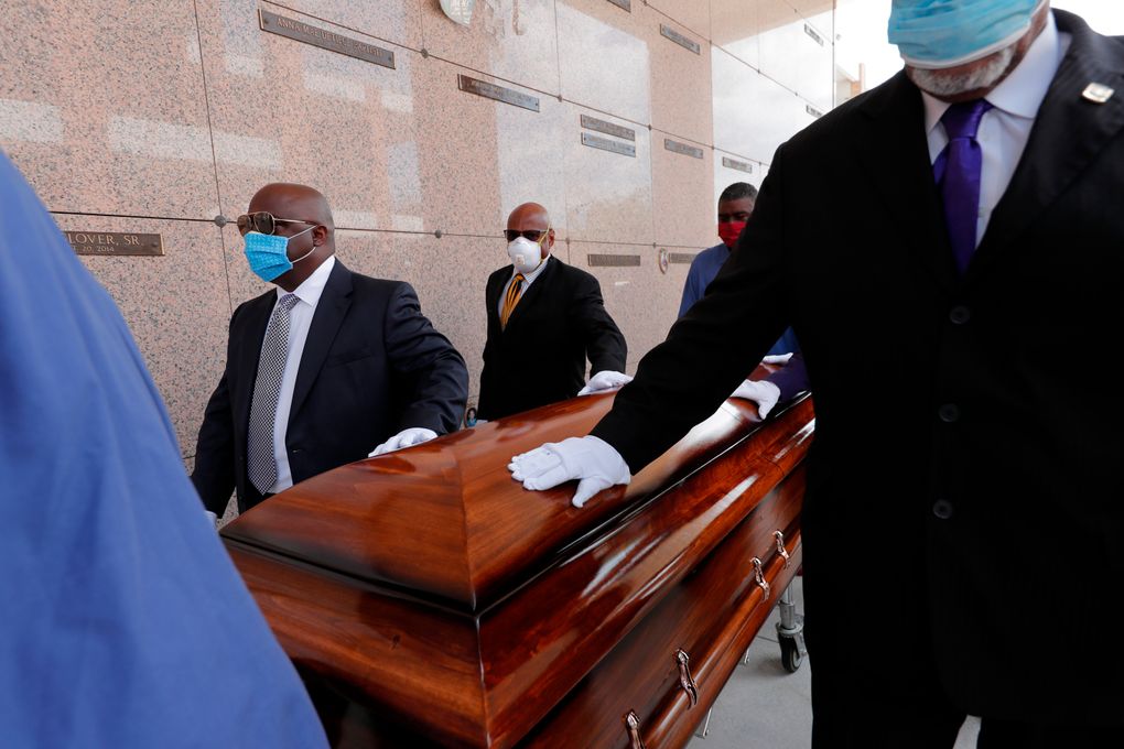 FILE – In this April 22, 2020, file photo, pallbearers, who were among only 10 allowed mourners, walk the casket for internment at the funeral for Larry Hammond, who died from the coronavirus, at Mount Olivet Cemetery in New Orleans. Hammond was Mardi Gras royalty, and would have had hundreds of people marching behind his casket in second-line parades. (AP Photo/Gerald Herbert, File)
