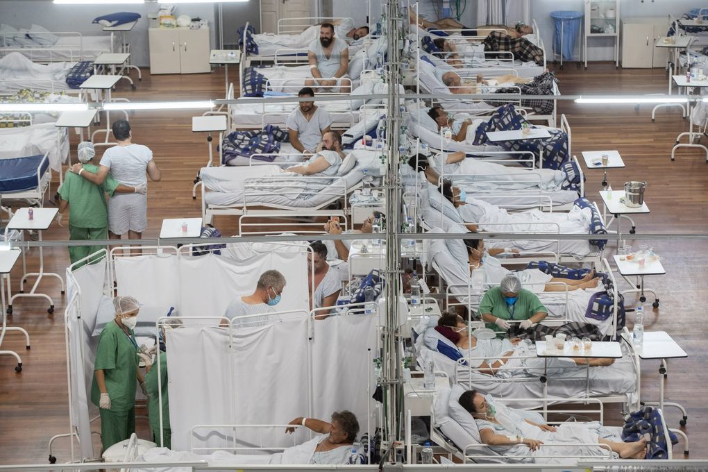 COVID-19 patients lie on beds at a field hospital built inside a sports coliseum in Santo Andre  on the outskirts of Sao Paulo, Brazil, on Thursday. (Andre Penner / The Associated Press)