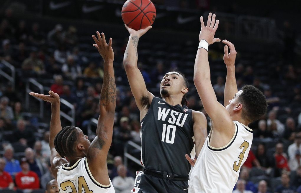 In this March 11, 2020, file photo, Washington State’s Isaac Bonton (10) shoots over Colorado’s Eli Parquet (24) and Maddox Daniels (3) during the first half of an NCAA college basketball game in the first round of the Pac-12 men’s tournament in Las Vegas.  (John Locher / AP)