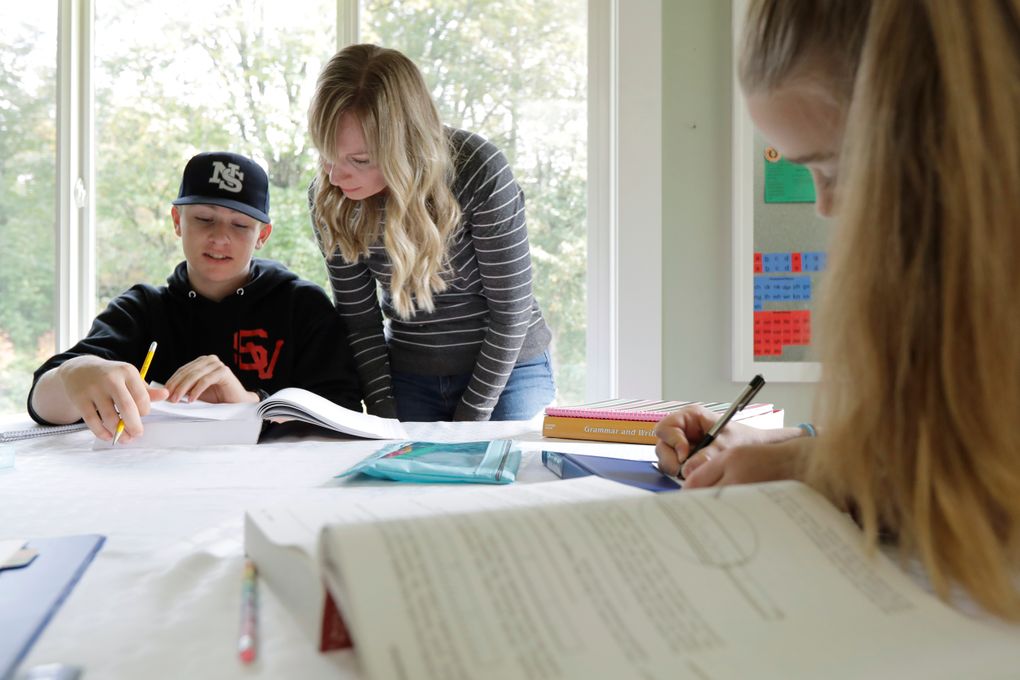 FILE – In this Oct. 9, 2019, photo, Donya Grant, center, works on a homeschool lesson with her son Kemper, 14, as her daughter Rowyn, 11, works at right, at their home in Monroe, Wash. The rate of households homeschooling their children doubled from the start of the pandemic last spring to the start of the new school year last September, according to a new U.S. Census Bureau report released this week. (AP Photo/Ted S. Warren, File)