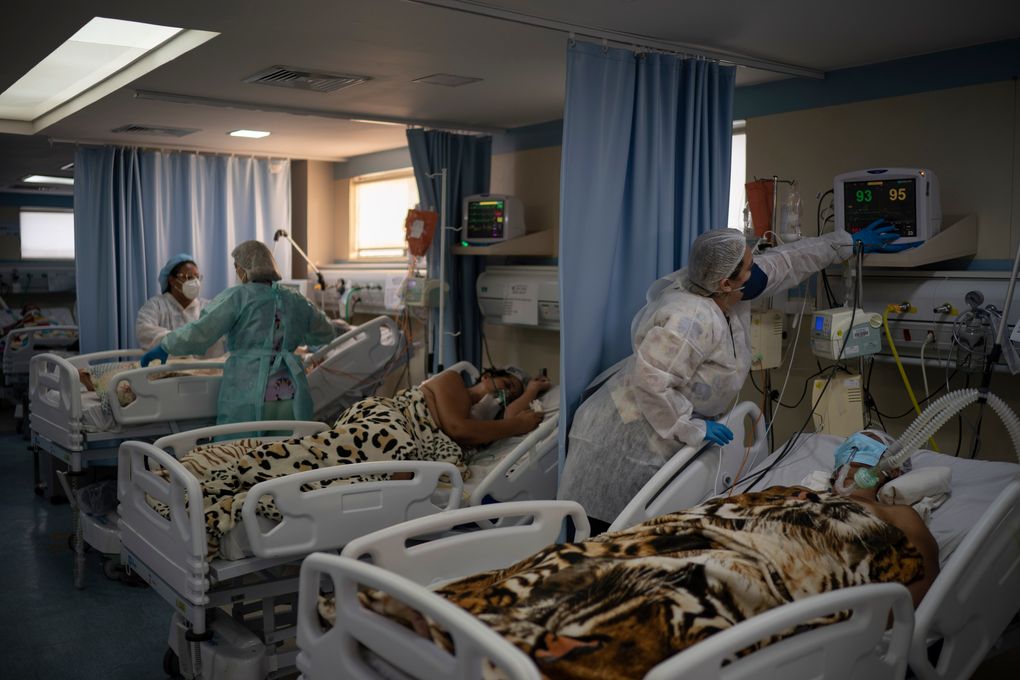 COVID-19 patients are treated in the ICU of the São José municipal hospital, in Duque de Caxias, Brazil, Wednesday, March 24, 2021. In Brazil, where the coronavirus is still surging — daily deaths hit a record 3,251 Tuesday — this is now the life of a doctor: an unending succession of life-or-death decisions, and grappling with the mental trauma that follows. (Felipe Dana / AP)