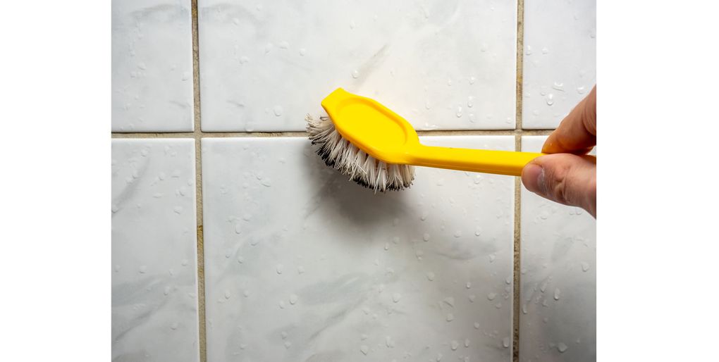 To remove mold in grout lines, use a scrubbing brush and a cleaner that offers future protection. (Getty Images)