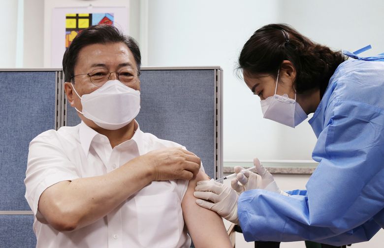 South Korean President Moon Jae-in, left, receives his second dose of the AstraZeneca COVID-19 vaccine at a health care center in Seoul, South Korea, Friday, April 30, 2021. (Lee Jin-wook/Yonhap via AP)
