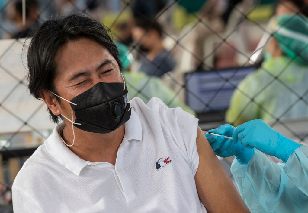 A health worker administers a dose of the Sinovac COVID-19 vaccine to a worker in a local entertainment venue area where a new cluster of COVID-19 infections were found in Bangkok, Thailand, Wednesday, April 7, 2021. Officials in Thailand’s capital have ordered a two-week closure of all entertainment venues in three districts to try to limit the spread of the coronavirus from nightspots there. (AP Photo/Sakchai Lalit)
