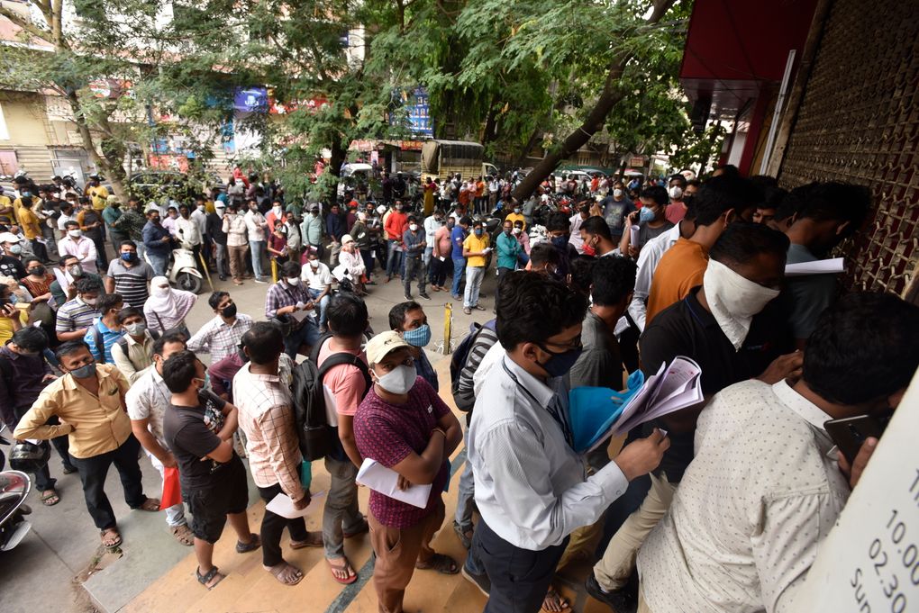 FILE- In this April 8, 2021 file photo, people wait in queues outside the office of the Chemists Association to demand necessary supply of the anti-viral drug Remdesivir, in Pune, India. As India faces a devastating surge of new coronavirus infections overwhelming the health care system, people are turning to desperate measures to keep loved ones alive. (AP Photo, File)