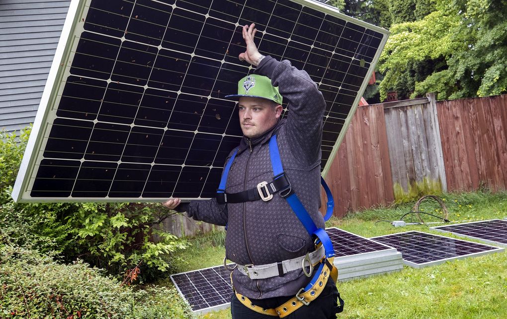 After two layoffs last year, Nick Bottomley left his 15-year career in food service and went back to school. He’s now a solar energy technician working for Puget Sound Solar. (Ellen M. Banner / The Seattle Times)