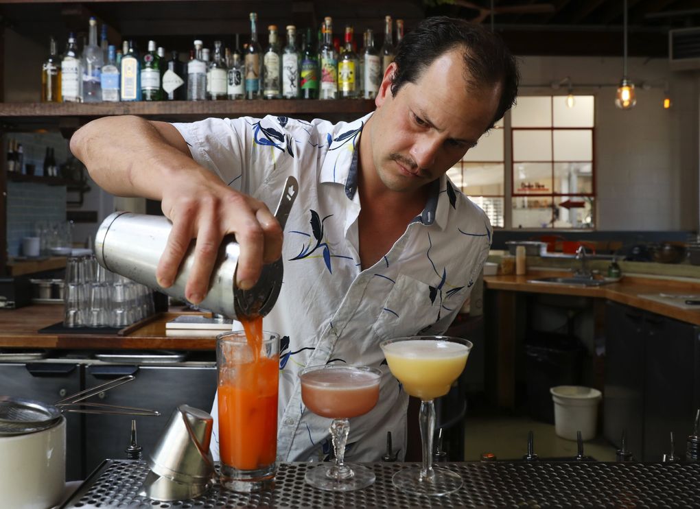 Patrick Thalasinos, pictured here in a file photo from August 2020, is the bar manager at Manolin, and he will sling some tropical cocktails for you to enjoy in the restaurant’s outdoor dining area. (Ken Lambert / The Seattle Times)