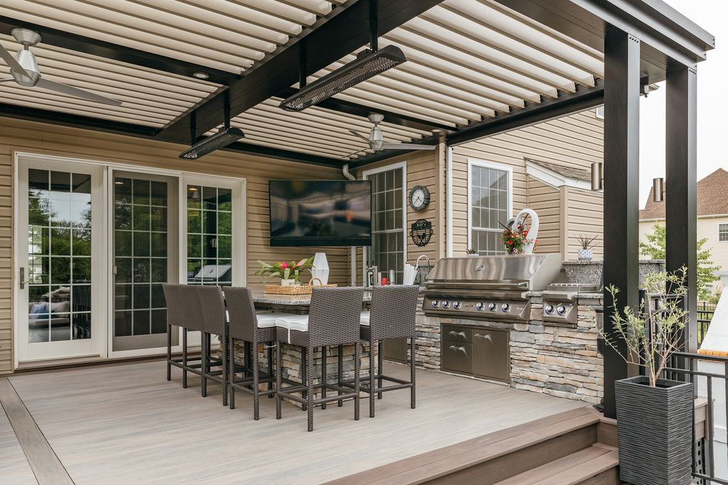 Bill Paliouras’ outdoor kitchen and dining area has a louvered ceiling, fans, infrared heat and a television. (Photo for The Washington Post by Melanie Landsman)