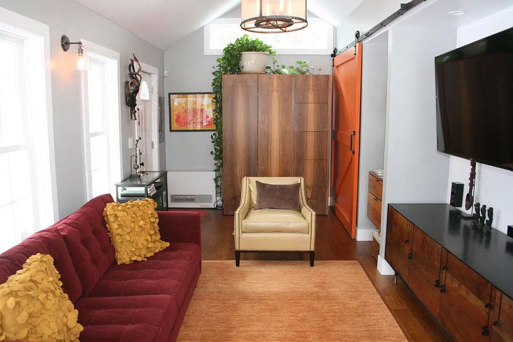 This home office/studio features a bold sofa and a sliding barn door, two trends that could become dated over time. (Tribune News Service file photo)
