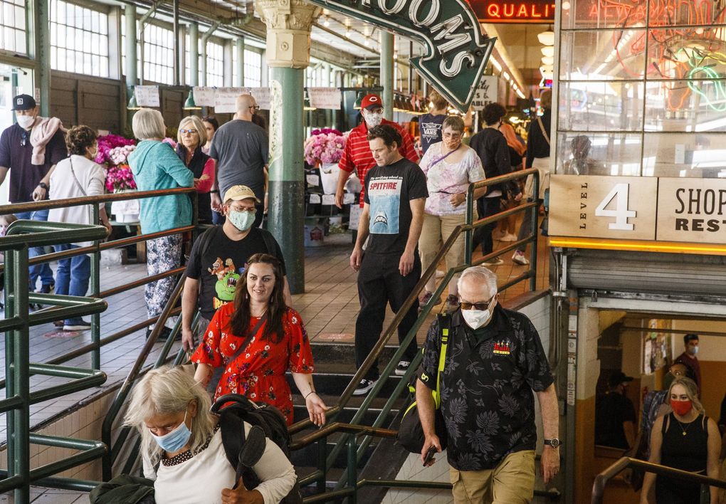 Locals and tourists venture around Seattle’s Pike Place Market.
