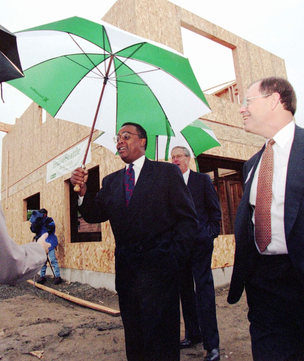 Former Seattle Mayor Norm Rice is shown in October 1996 with then-Boeing President Phil Condit, right, and Fannie Mae Chairman James Johnson. Johnson announced new   housing initiatives to help families rehabilitate or make a down payment on homes. (Loren Callahan / The Associated Press, file)