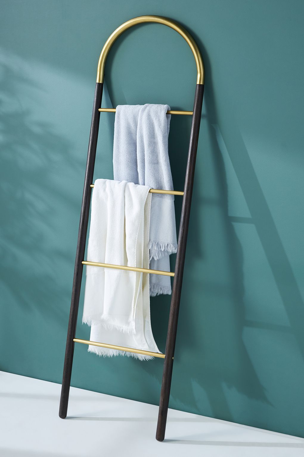The Anthropologie Avery Ladder is made of natural wood with brushed-brass accents. (Courtesy of Anthropologie)