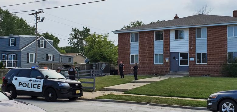 Kenosha police investigate a shooting at 40th Avenue and 45th Street on the city’s north side Tuesday, Aug. 10, 2021, in Kenosha, Wis. A 19-year-old woman was using a handgun’s laser sight as a cat toy when she accidentally shot a friend, according to prosecutors. The 19-year-old woman was charged Thursday with injury by negligent use of a weapon. (Terry Flores/The Kenosha News via AP)