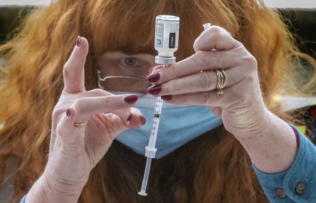 A community health program manager and registered nurse prepares a coronavirus vaccine in Suquamish