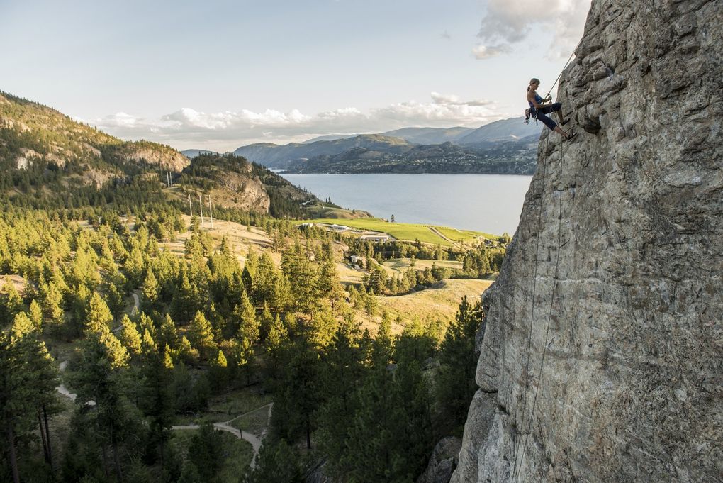 A climber rests while climbing a rock wall in Skaha Bluffs Provincial Park in British Columbia.  (Kari Medig / Destination BC)