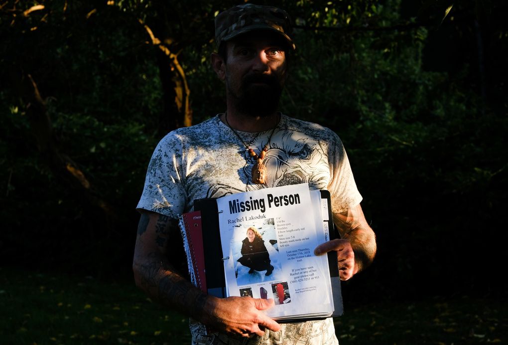 Carlton “Bud” Carr Jr. poses for a photo on Monday, Aug. 23, 2021, in the backyard of his home in Concrete, Wash Carr is holding the file containing his search notes on Rachel Lakoduk, a 28-year-old Moses Lake hiker who went missing on Oct. 17, 2019, while attempting to reach Hidden Lake Lookout – a remote fire lookout in the Mt. Baker – Snoqualmie National Forest. Carr owns and operates 49th Parallel, a private search and rescue group located in Concrete and spent at least 70 days searching for Rachel. (Tyler Tjomsland / The Spokesman-Review)