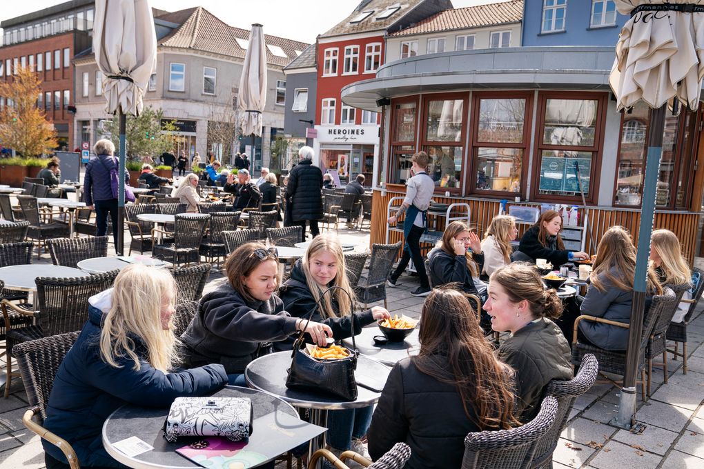 FILE – In this Wednesday April 21, 2021 file photo, people sit outside a restaurant for outdoor service in Roskilde Denmark, as cafes and bars reopened. After 548 days with restrictions to limit the spread of COVID-19, Denmark’s high vaccination rate has enabled the Scandinavian country to become one of the first European Union nations to lift all domestic restrictions. The return to normality has been gradual, but as of Friday Sept. 10, 2021, the digital pass — a proof of having been vaccinated — is no longer required when entering night clubs, making it the last virus safeguard to fall. (Claus Bech/Ritzau Scanpix via AP, File)