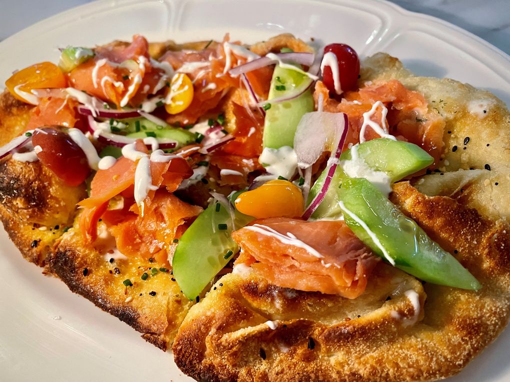 The Everything spiced flatbread, Cedar + Elm: A play on the lox bagel, this flatbread is covered with garlic, onion, celery salt, poppy and sesame seeds and topped with applewood-smoked Chinook salmon, among other delicious items. (Ken Lambert / The Seattle Times)