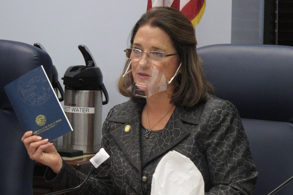 Alaska state Sen. Lora Reinbold, an Eagle River Republican, in January holds a copy of the Alaska Constitution during a committee hearing in Juneau. Reinbold has tested positive for COVID-19 and is quarantining at home. (Becky Bohrer / The Associated Press, file)