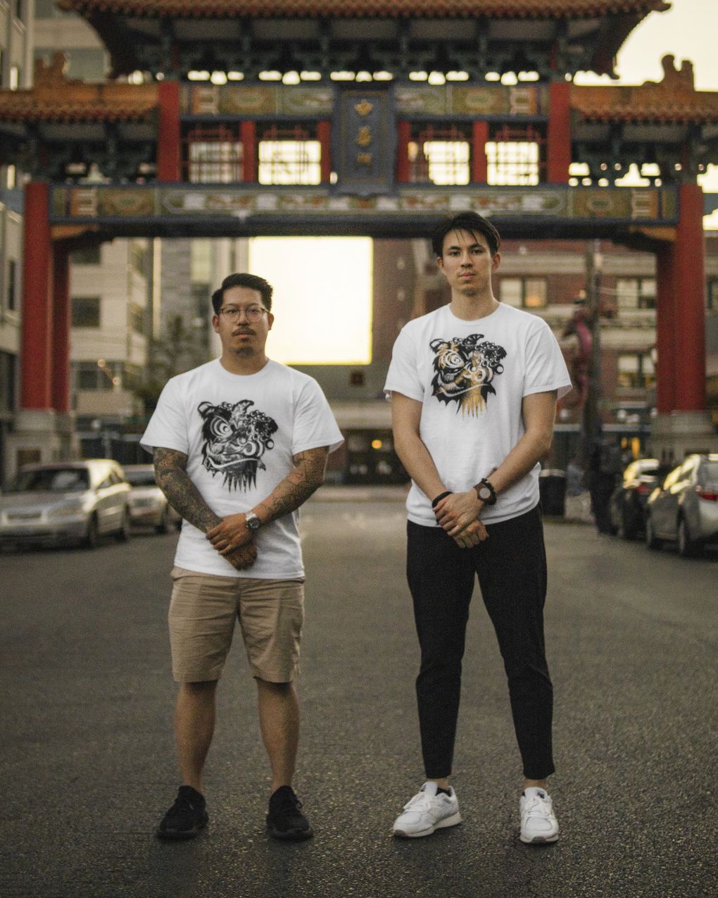 PRSVRNC Clothing founders Royal Tan and Han Eckelberg pose across from Hing Hay Park in the Chinatown International District. The duo’s goal, with clothing and accessories depicting Chinese cultural symbols, is to “bring Asian American pride, cultural items and the meanings of Asian American culture into clothing.” (Wen Eckelberg)