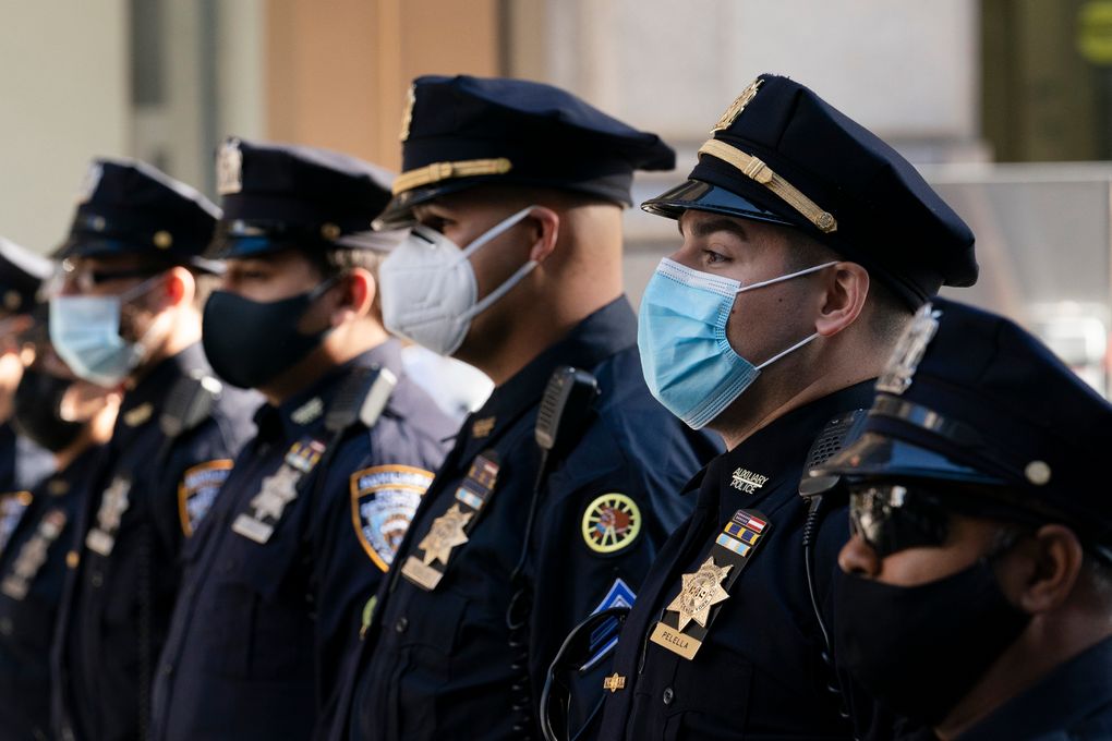 FILE – In this Oct. 5, 2020, file photo, New York Police Department officers in masks stand during a service at St. Patrick’s Cathedral in New York to honor 46 colleagues who have died due to COVID-19 related illness. A New York judge on Wednesday refused to pause a COVID-19 vaccine mandate set to begin Friday for the city’s municipal workforce, denying a police union’s request for a temporary restraining order. (AP Photo/Mark Lennihan, File)