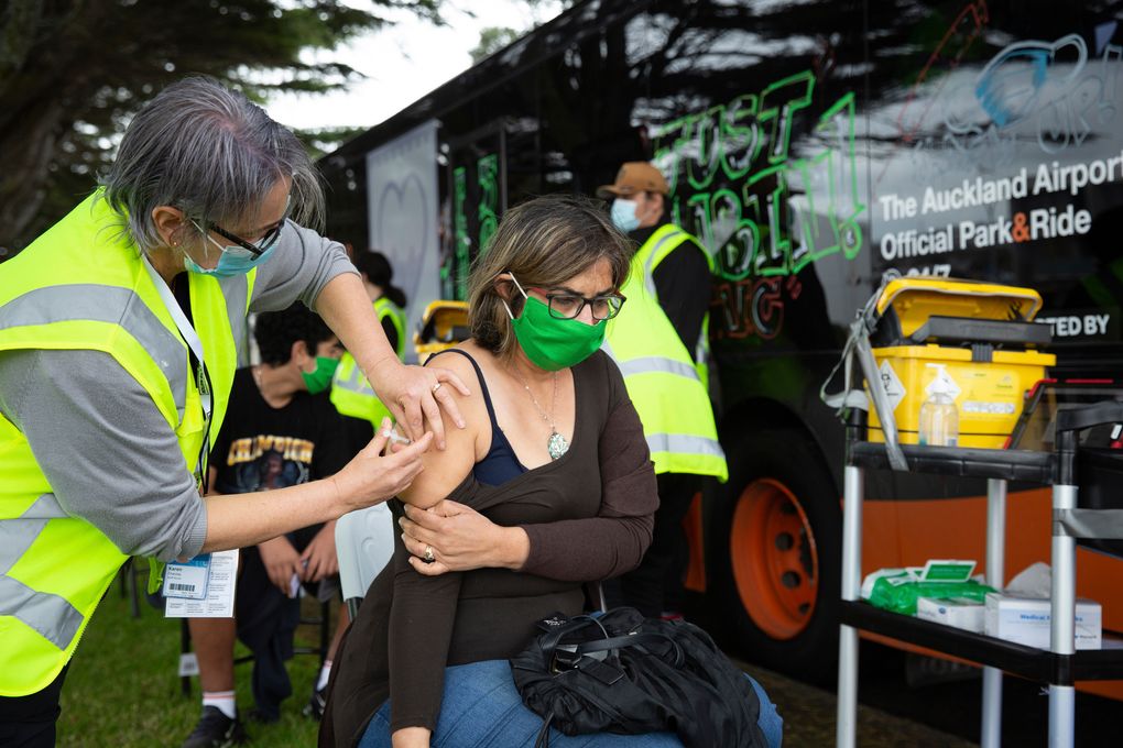 A health worker administers vaccinations at a mobile clinic Oct. 7, 2021, in Auckland, New Zealand. New Zealand’s doctors and teachers are among those who must soon be fully vaccinated against the coronavirus to continue working in their professions, the government announced Monday, Oct. 11, 2021. (Sylvie Whinray/New Zealand Herald via AP)