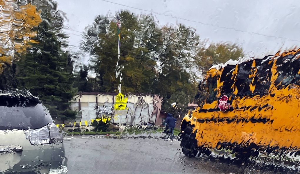 A rain-distorted school bus waits for students at John Rogers Elementary in Seattle.