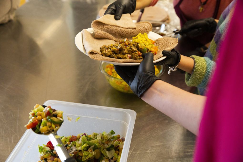 East African food is served at Northgate Community Center, in a program that offers — at sites around King County — meals, exercise, groceries to take home and a chance to socialize. (Daniel Kim / The Seattle Times)