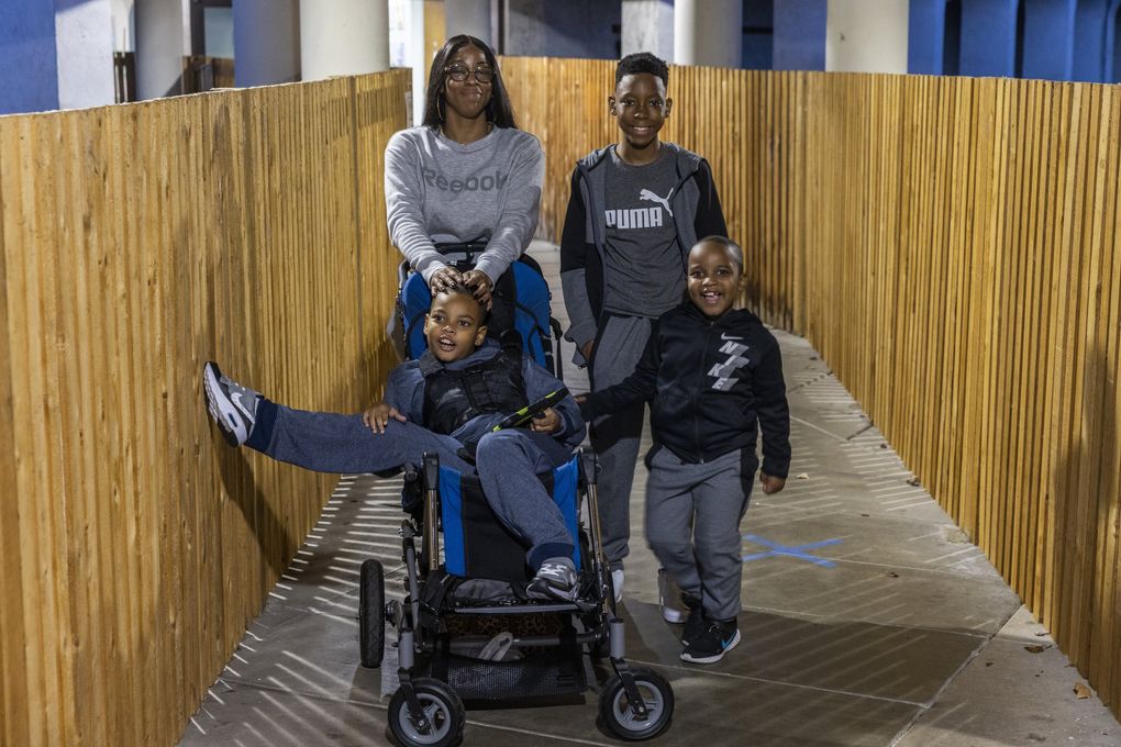 Carneisha Grace stands outside with her children Josiah, top right, Samari, right, and Shawn at Childhaven’s Auburn branch. “I feel like we are doing great,” Grace said.  (Daniel Kim / The Seattle Times)
