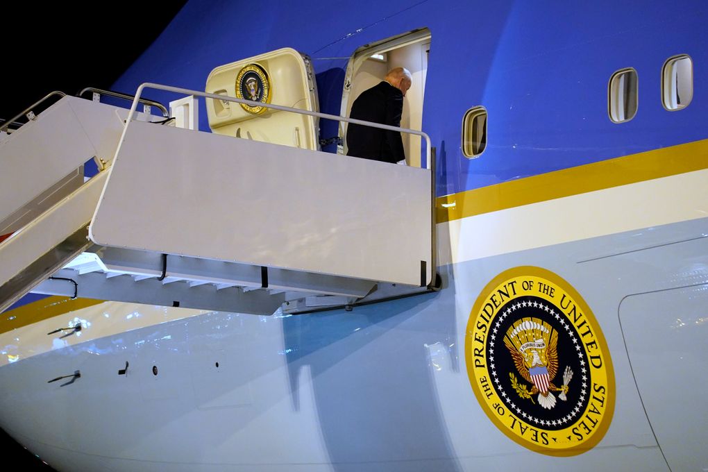 President Joe Biden boards Air Force One on Tuesday after attending the U.N. Climate Change Conference in Edinburgh, Scotland. (AP Photo/Evan Vucci)